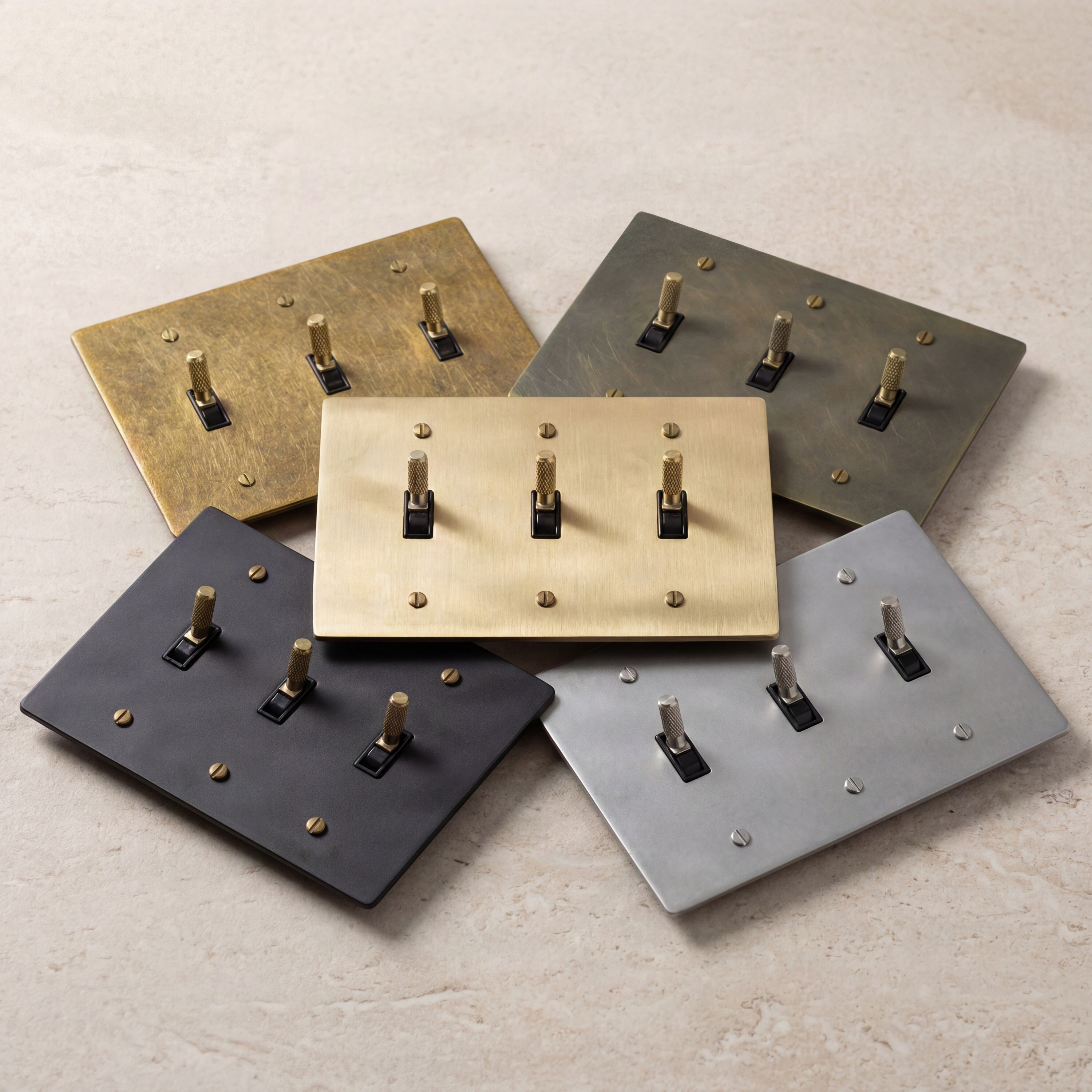 Five 3-gang toggle switches with knurled toggles, varied finishes.