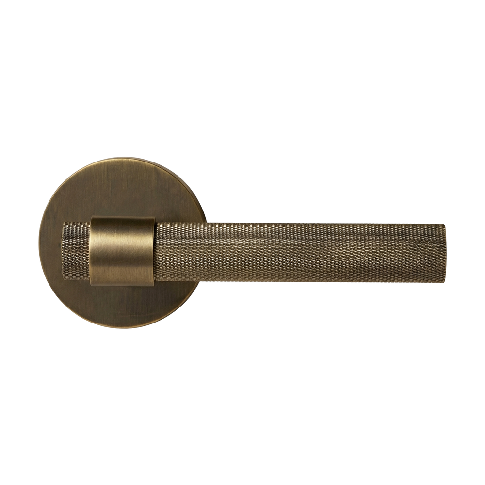 A sophisticated aged brass lever handle with a knurled texture and timeless design.