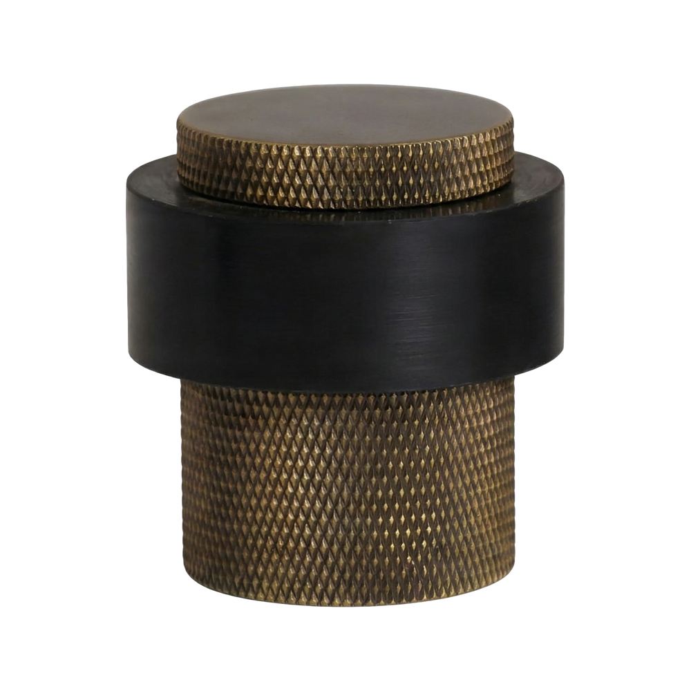 Heirloom-quality aged brass heavy duty floor mount door stop, knurled and robust, featuring a sleek black band.