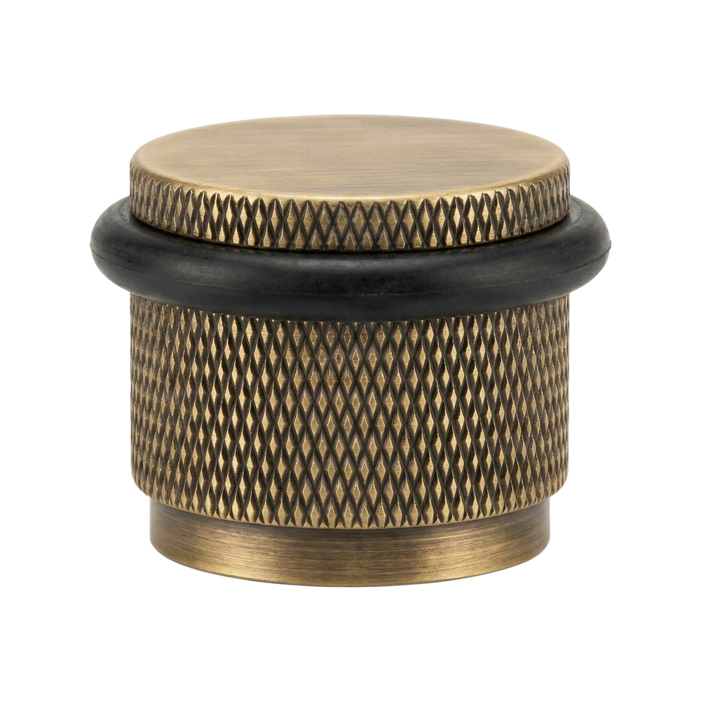 Timeless aged brass floor mount door stop, handcrafted with precise knurled texture.