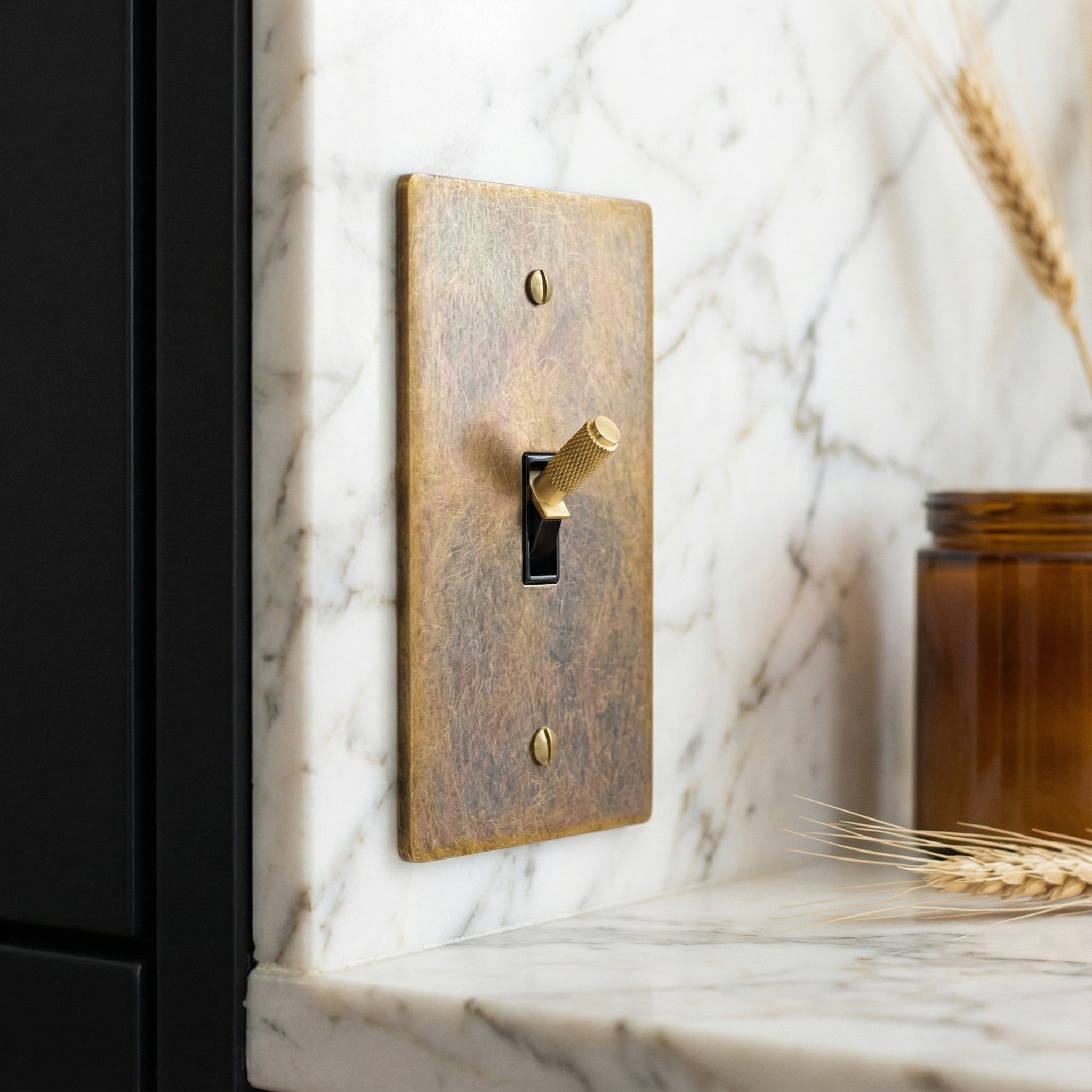 Aged brass 1 gang toggle switch plate on marble, a quietly luxurious and timeless accent.
