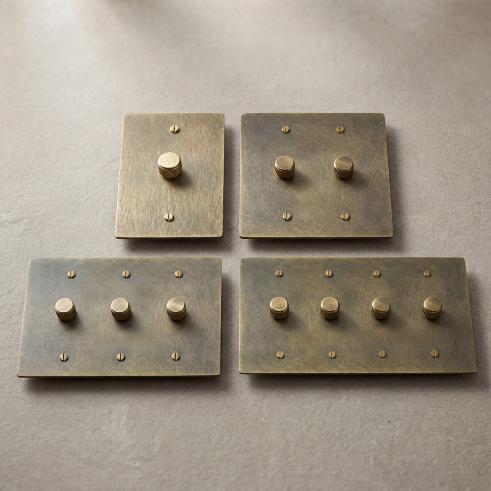 Antique brass dimmer switches, knurled knobs, and authentic patina.