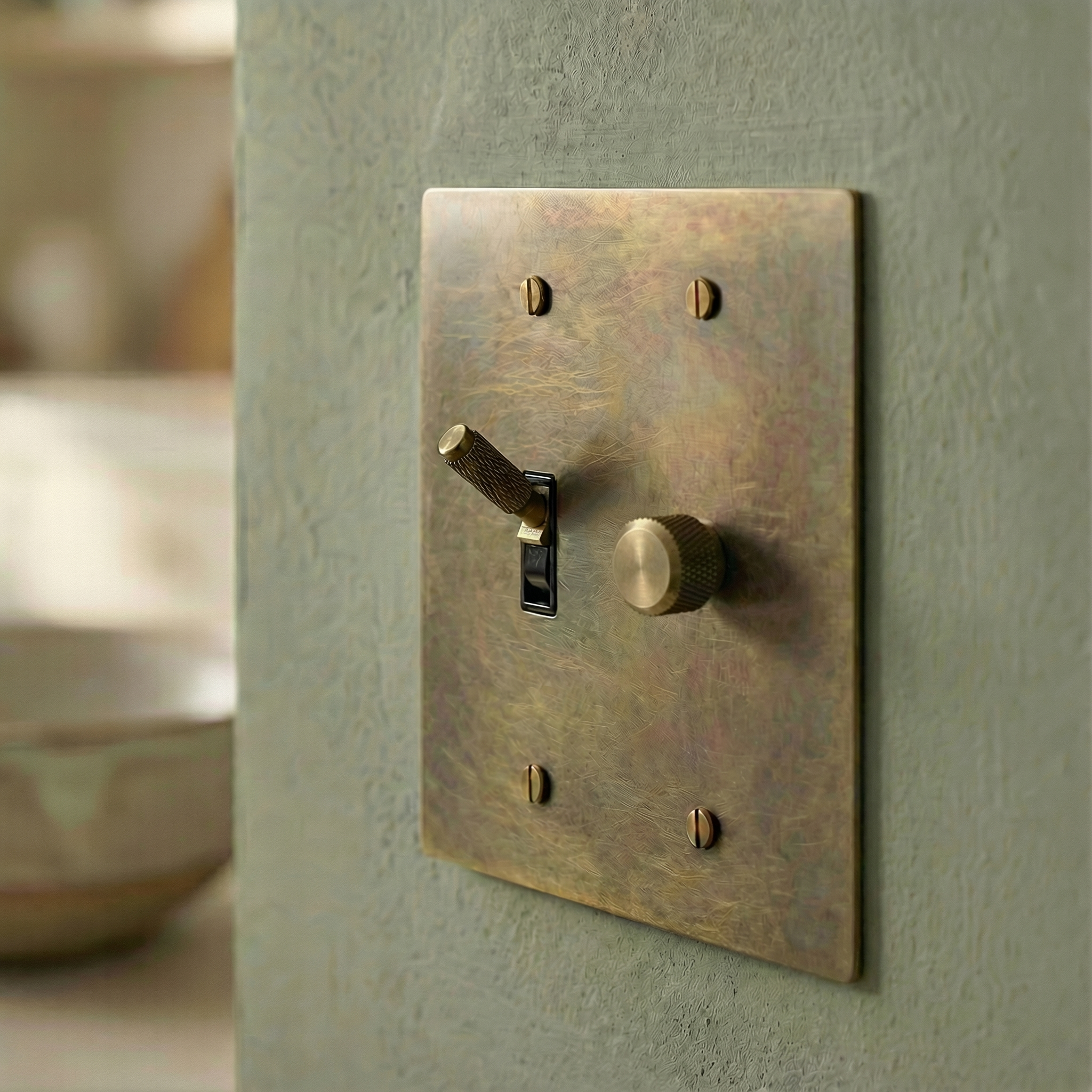 Heirloom quality antique brass 2 gang dimmer and toggle switch plate on a textured wall, timeless elegance.