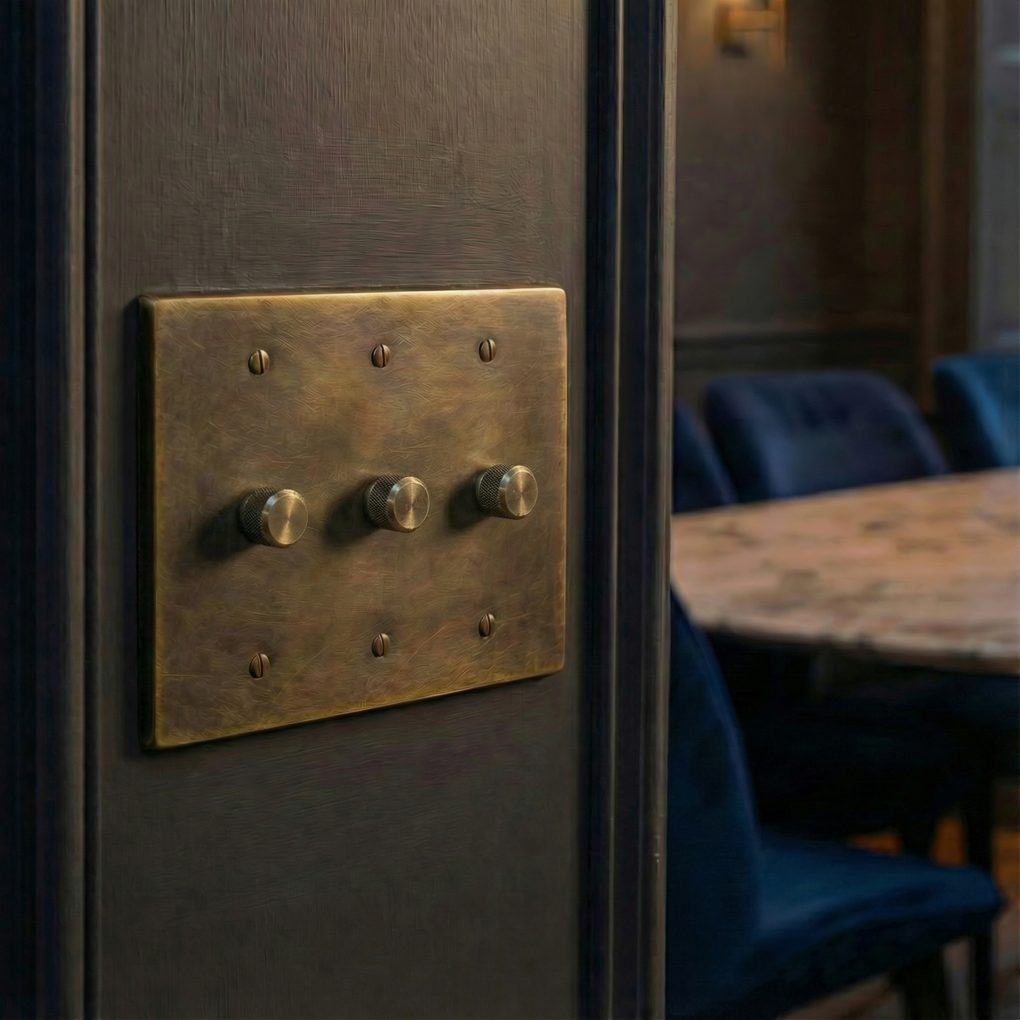 Heirloom quality antique brass 3 gang dimmer switch plate enhancing a timeless, elegant interior.