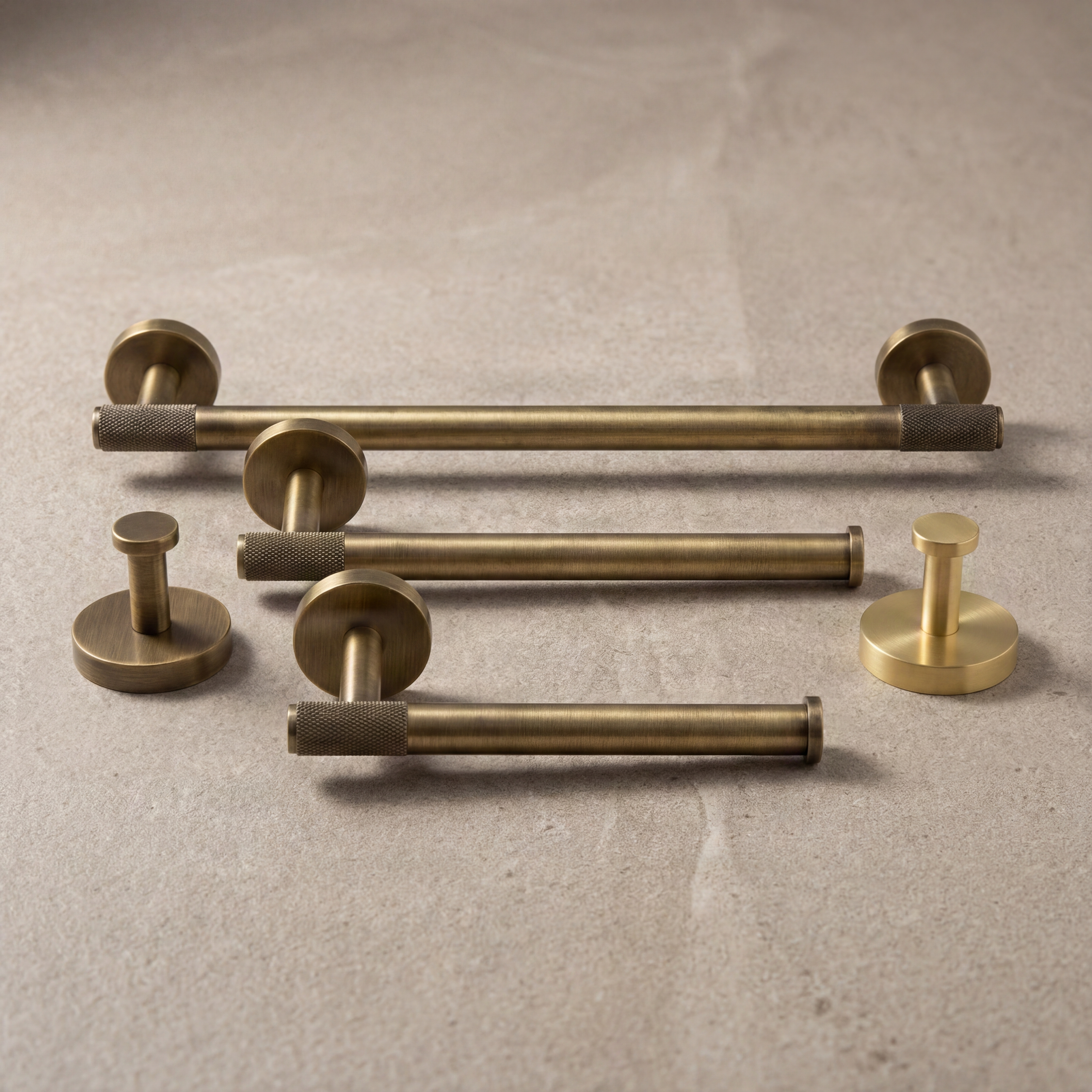 Knurled brass bathroom hardware in aged and satin finishes.