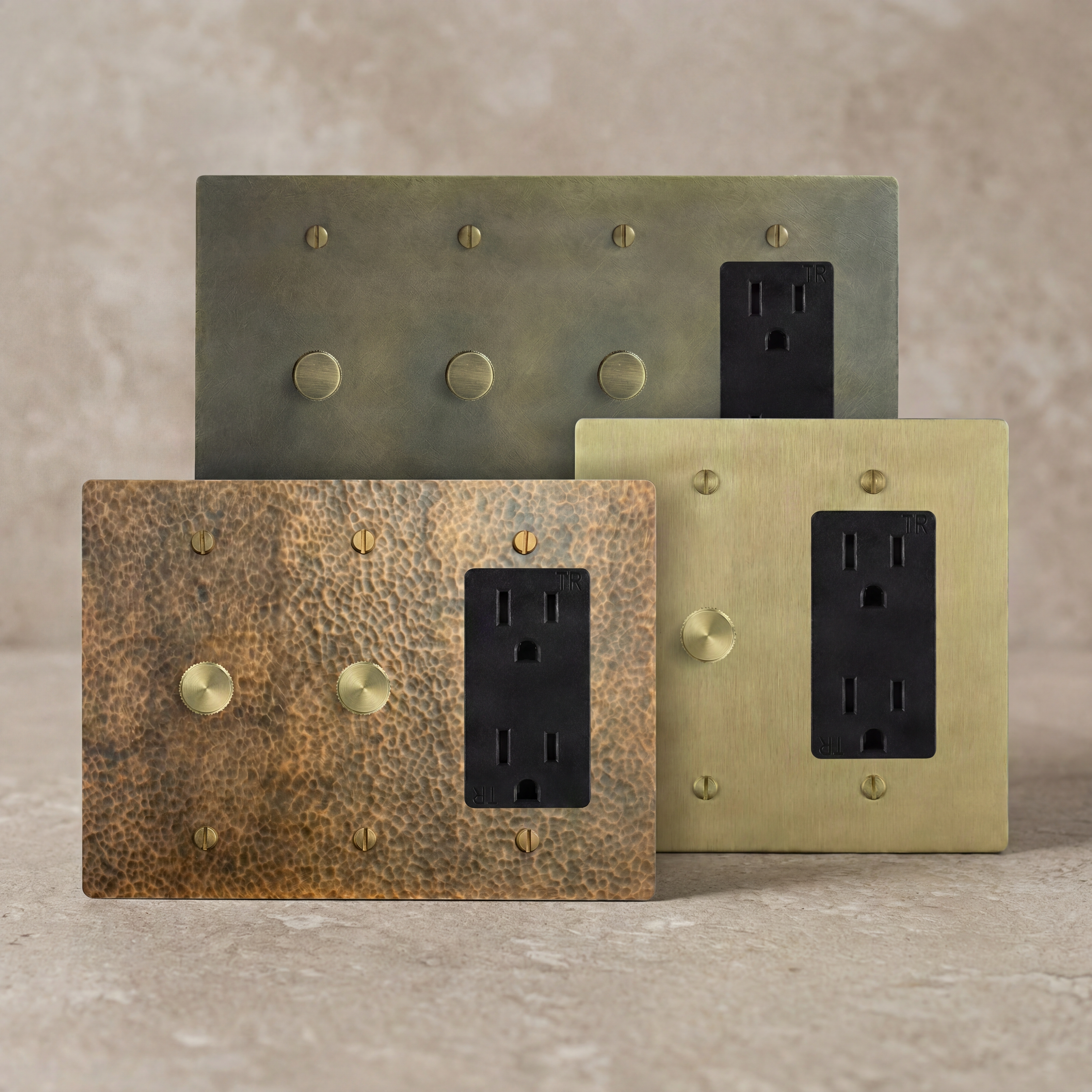 Solid brass dimmer outlets, each with a distinctive patina.
