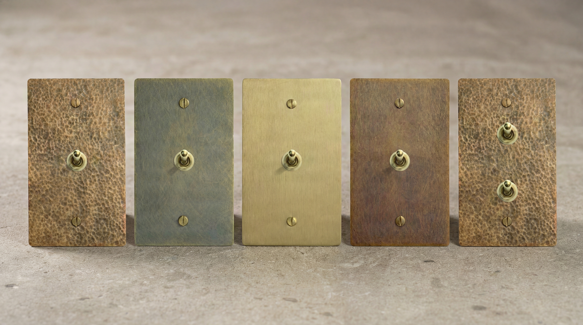 Five solid brass Brass Vintage Toggle Switches, diverse antique, aged, and satin finishes, enduring craftsmanship.