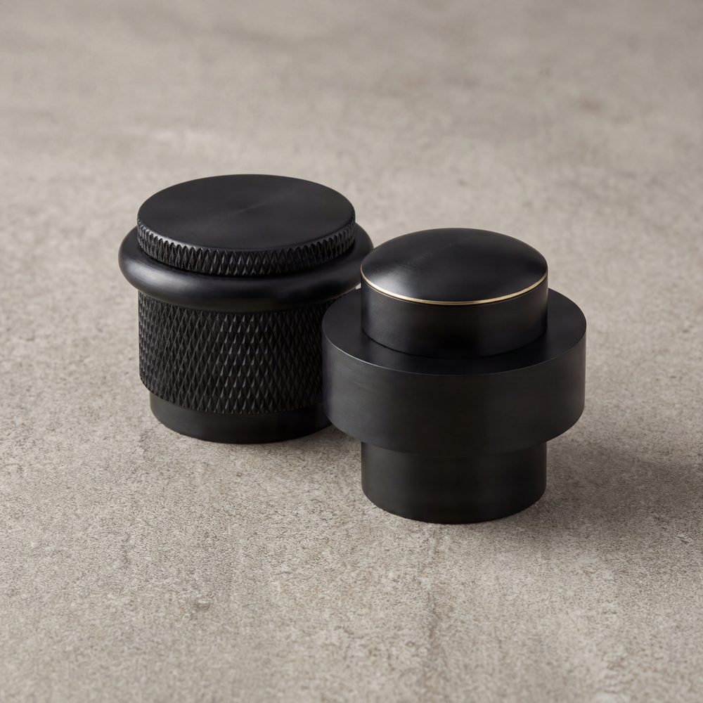Heirloom-quality black fixtures; one knurled, one with a gold accent.