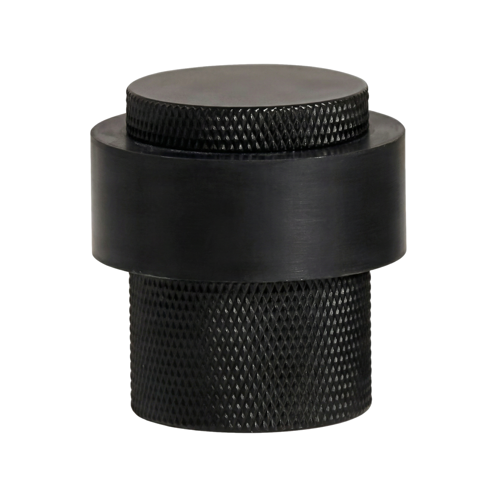 Matte black heavy duty floor mount door stop, precisely crafted with knurled and brushed textures.