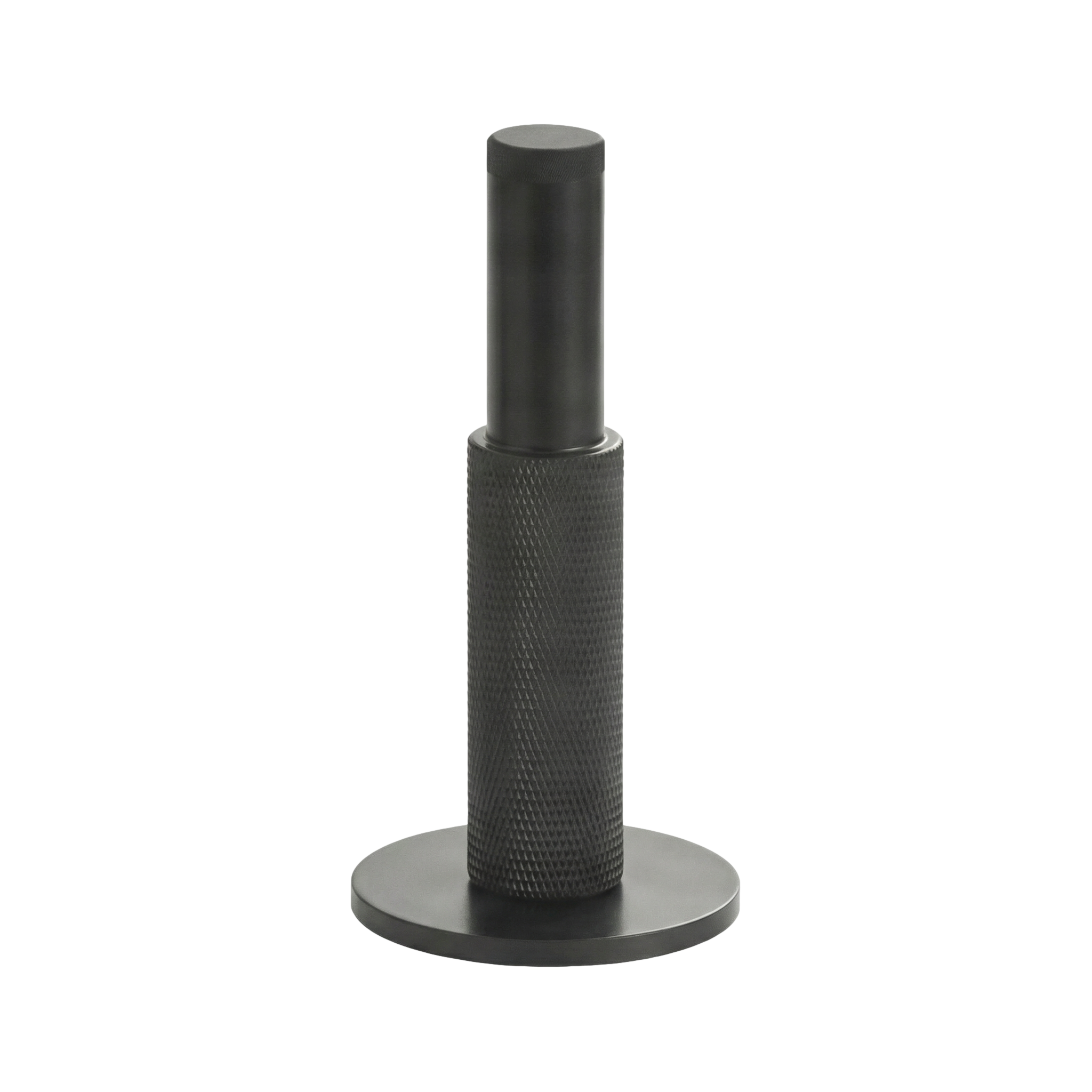 Matte black wall mount door stop with a tactile knurled texture, reflecting timeless minimalist design and solid craftsmanship.