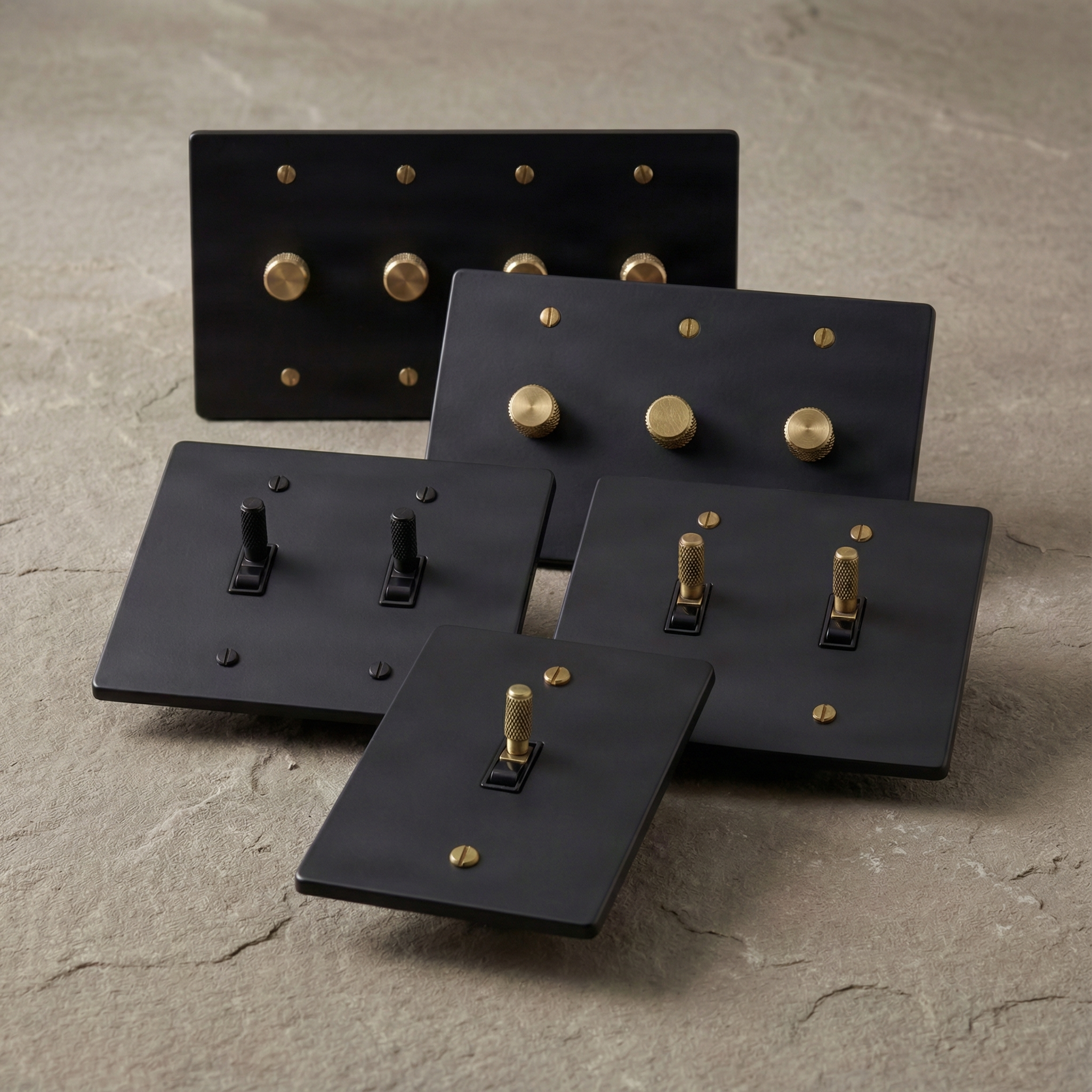 Elegant matte black switches with brass and black controls.
