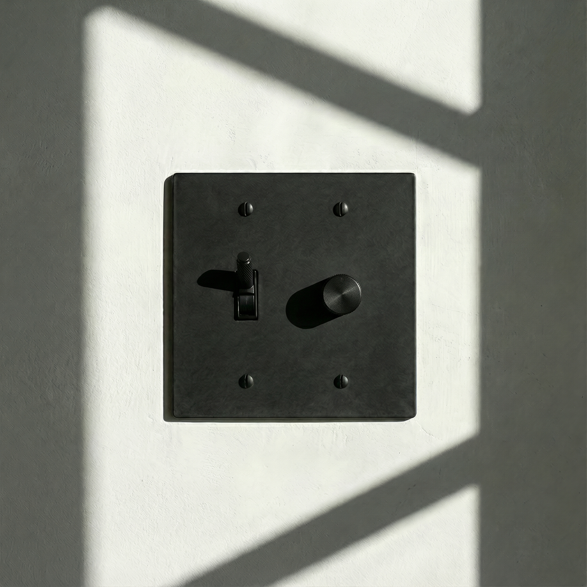 matte black (matte black accents) 2 gang dimmer and toggle switch plate casts elegant shadows on a textured wall, embodying quiet luxury.