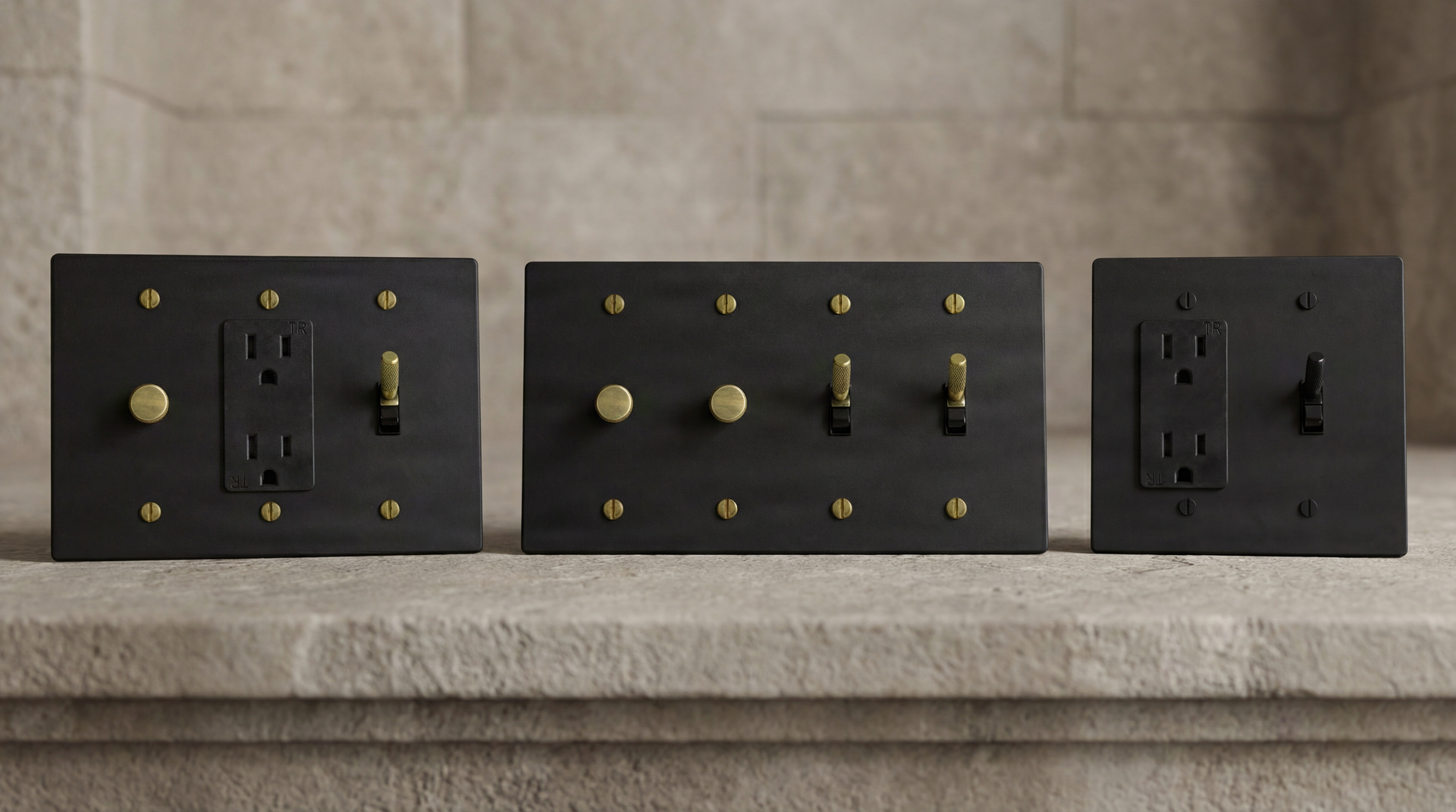 Matte Black Toggle Switches: various gang plates with knurled brass and dark toggles. Timeless craftsmanship, quiet luxury.