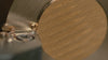 A brass dimmer knob being milled with precision on a lathe; the brass chips rolling smoothly off the tool head.