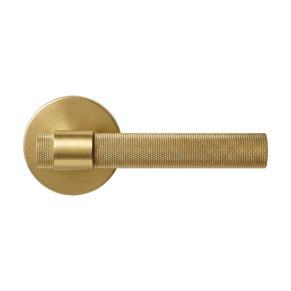 Solid satin brass lever handle with exquisite knurled texture, embodying timeless luxury and permanence.