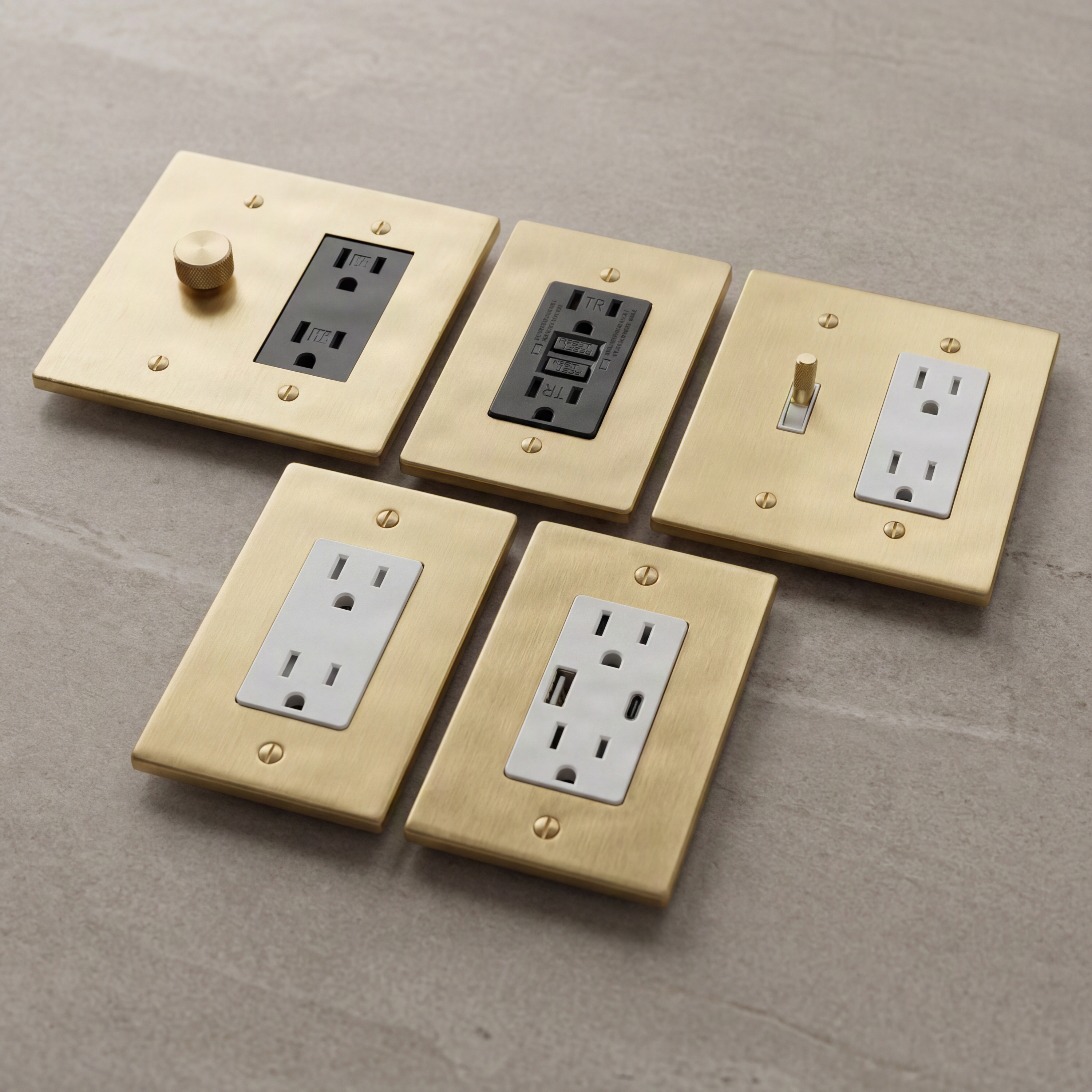 Satin brass wall plates with varied luxury electrical inserts