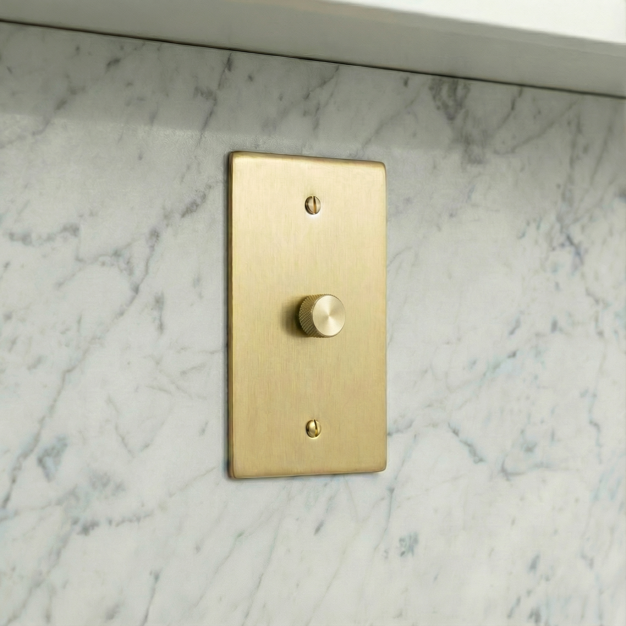 Satin brass 1 gang dimmer switch plate on timeless marble for quiet luxury.