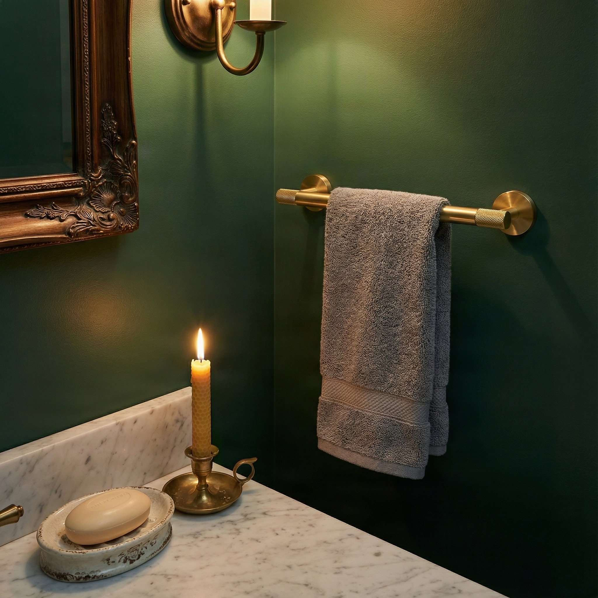 Timeless modern brass bathroom hardware 24 inch towel bar in a luxurious green and marble setting with candlelight.