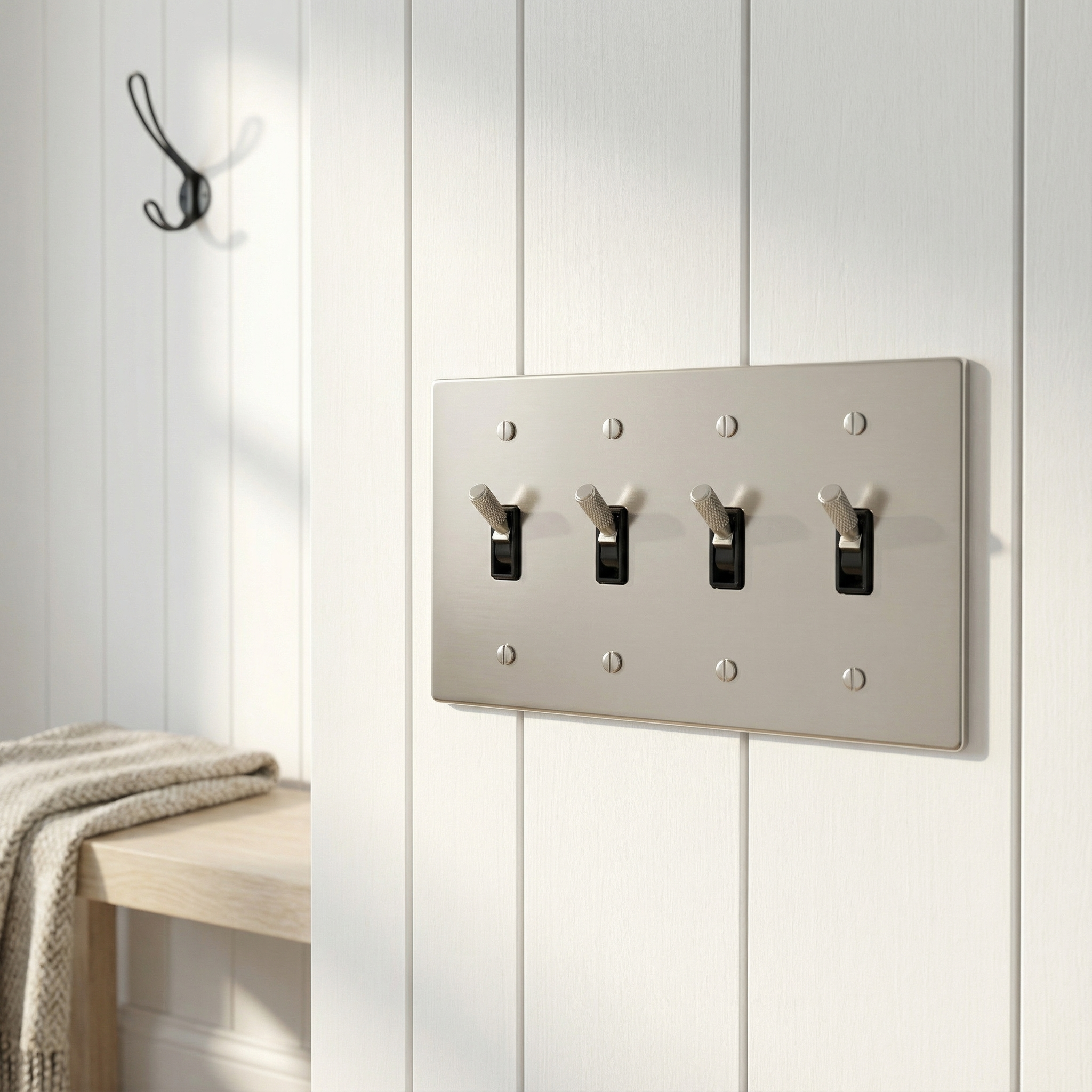 A satin nickel 4 gang toggle switch plate adds heirloom elegance to white wainscoting in a sunlit home.