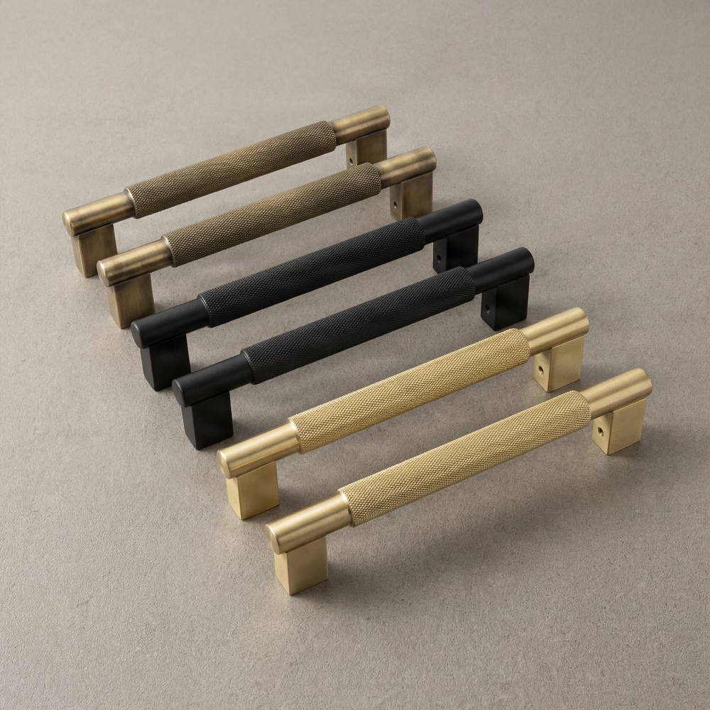 Knurled door pulls in aged brass, matte black, and satin brass.